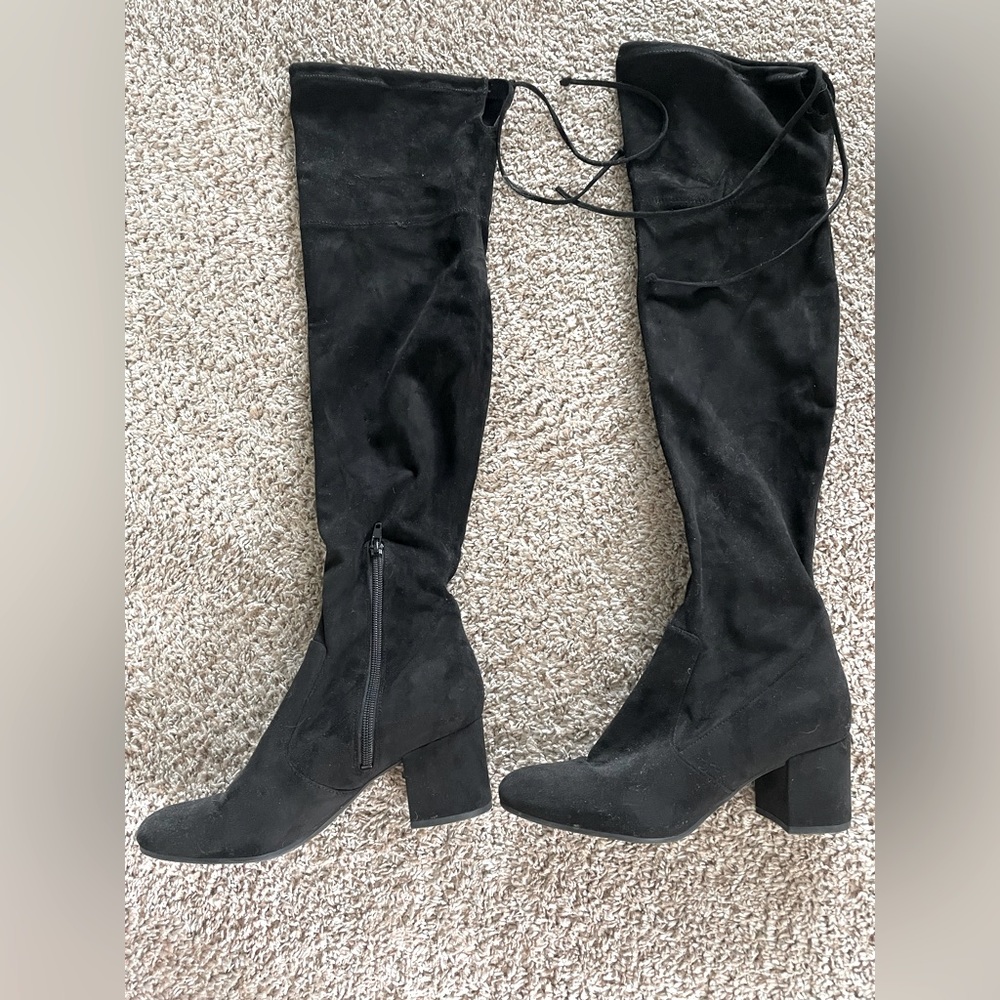 Women’s size 8 thigh high black boots with zipper and ties at top.